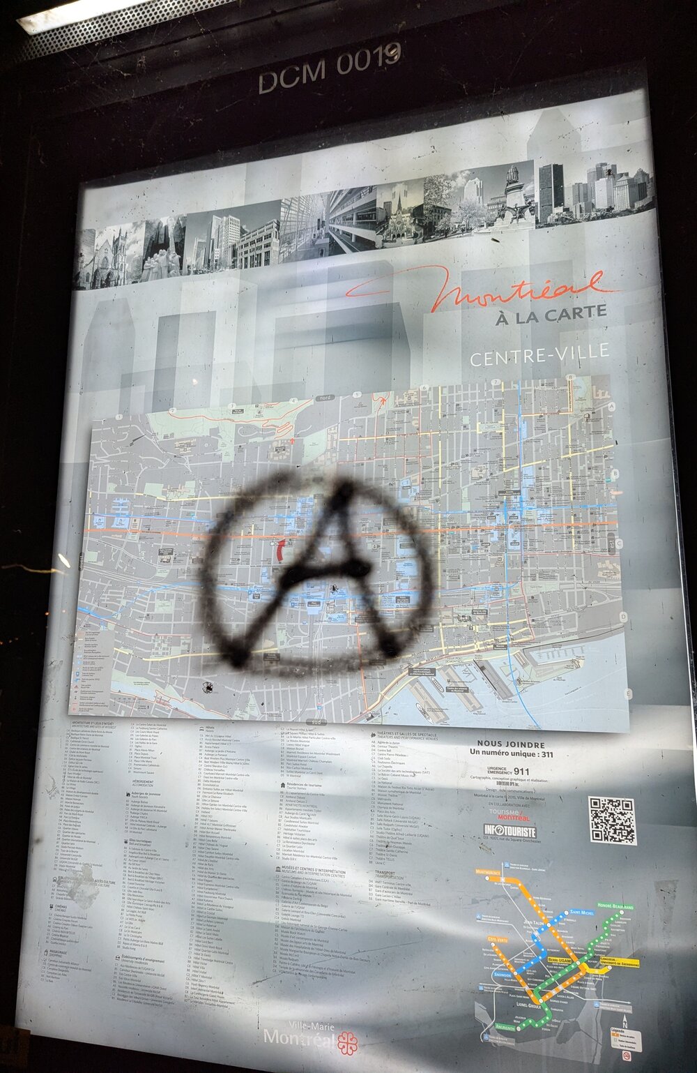 A spray painted anarchist symbol on a city map